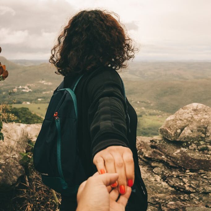 Woman Wearing Black Long-sleeved Shirt Holding Someone's Hand